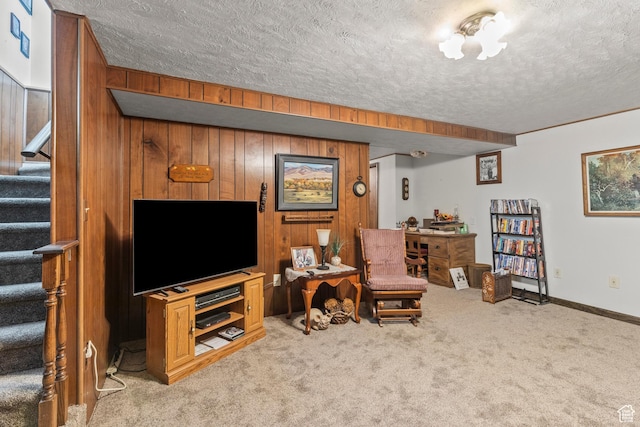 3647 Maple Creek Rd N, Franklin, ID 83237 - carpeted living room featuring stairs, a textured ceiling, wooden walls, and baseboards