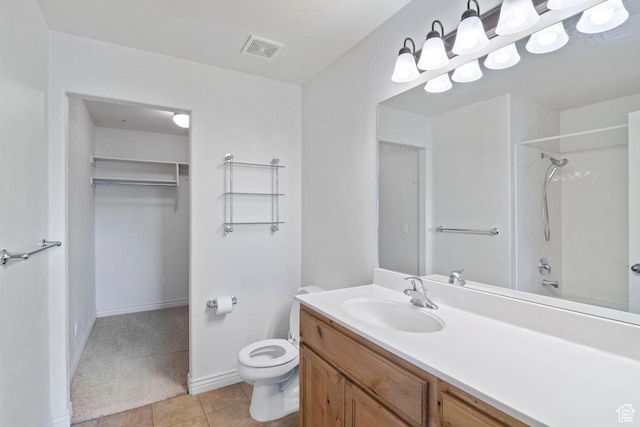 661 S 2220 W Unit 202, Pleasant Grove, UT 84062 - bathroom featuring toilet, vanity, tile patterned flooring, a walk in closet, and baseboards