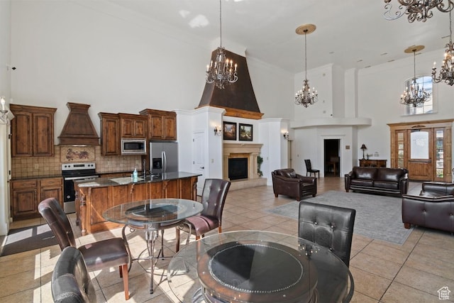 661 S 2220 W Unit 202, Pleasant Grove, UT 84062 - dining area with a chandelier, a high ceiling, a large fireplace, and light tile patterned floors