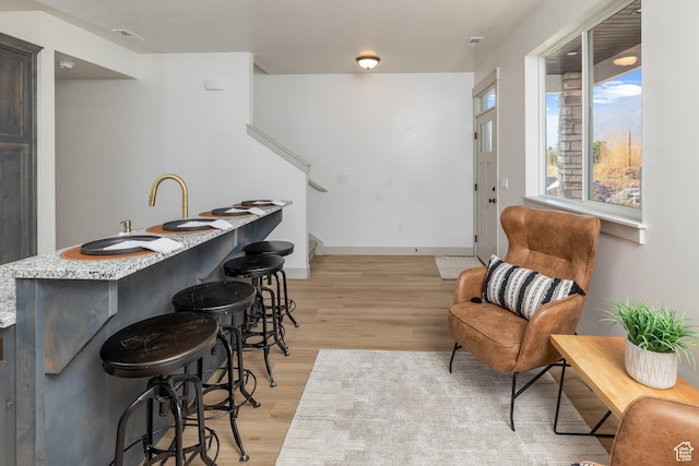 856 E 250 N, Hyrum, UT 84319 - indoor wet bar with light wood finished floors, stairs, and baseboards