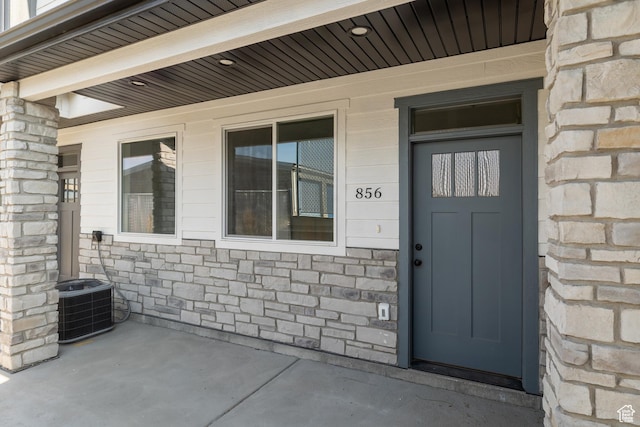 856 E 250 N, Hyrum, UT 84319 - doorway to property with central air condition unit and stone siding