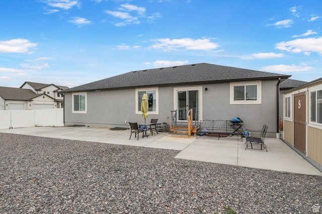 2256 E Boxwood Ln, Eagle Mountain, UT 84005 - back of house featuring a patio, fence, stucco siding, and roof with shingles