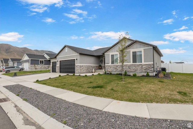 2256 E Boxwood Ln, Eagle Mountain, UT 84005 - view of front facade featuring stone siding, an attached garage, board and batten siding, driveway, and cooling unit