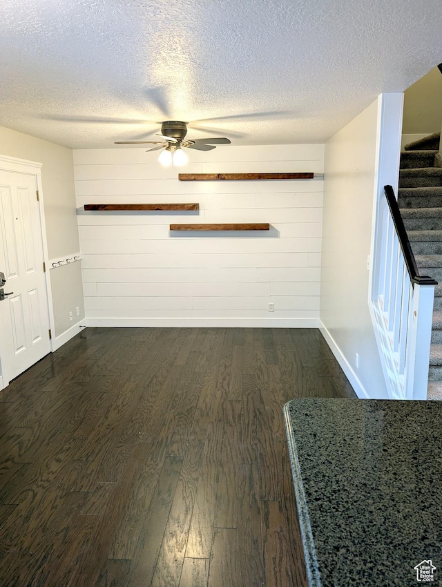266 W 1010 S, Logan, UT 84321 - unfurnished living room featuring baseboards, dark wood-style floors, ceiling fan, stairway, and a textured ceiling