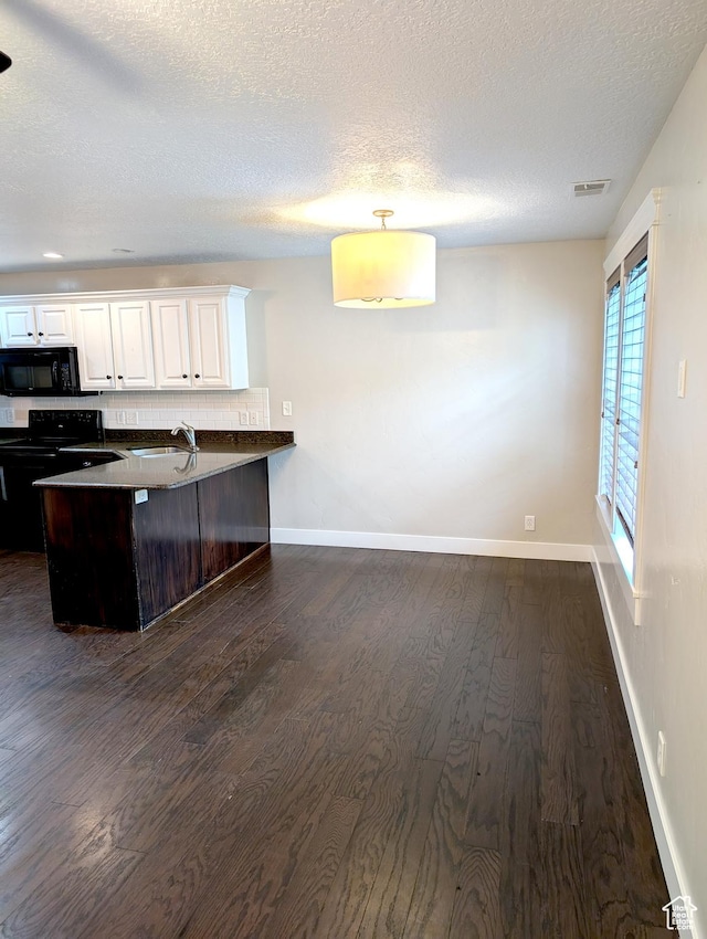 266 W 1010 S, Logan, UT 84321 - kitchen with black appliances, dark wood-style flooring, dark countertops, a sink, and white cabinets