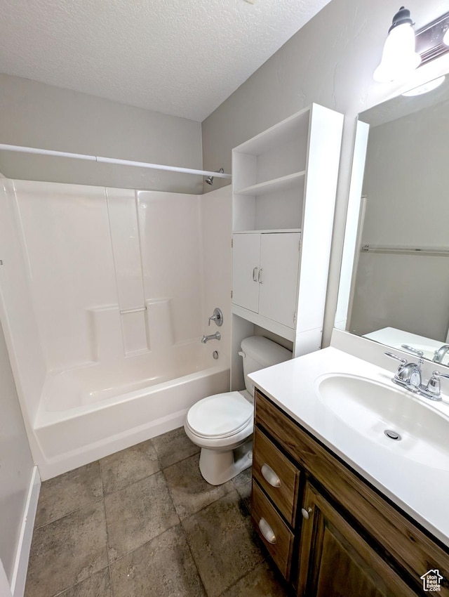266 W 1010 S, Logan, UT 84321 - bathroom featuring toilet, a textured ceiling, vanity, shower / tub combination, and baseboards