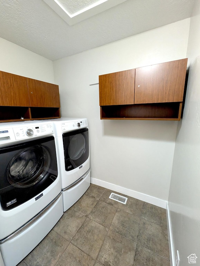 266 W 1010 S, Logan, UT 84321 - washroom featuring washing machine and dryer, baseboards, and cabinet space