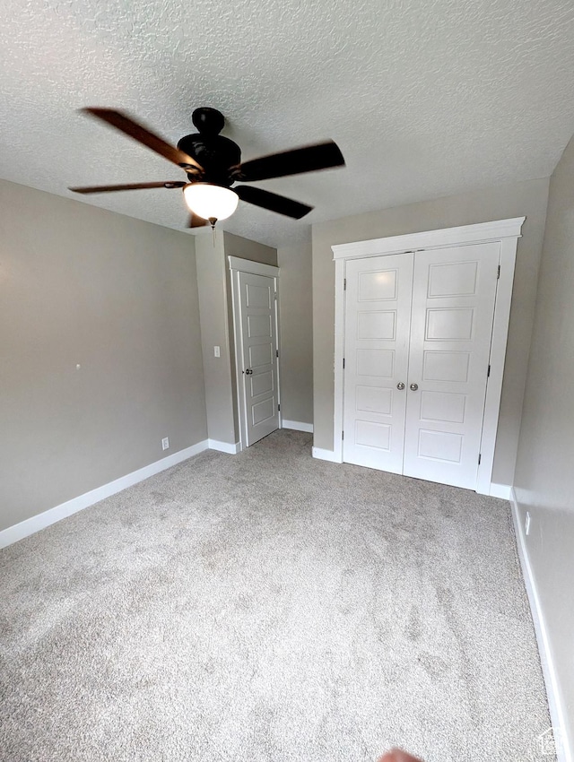 266 W 1010 S, Logan, UT 84321 - unfurnished bedroom featuring carpet floors, baseboards, a textured ceiling, a ceiling fan, and a closet