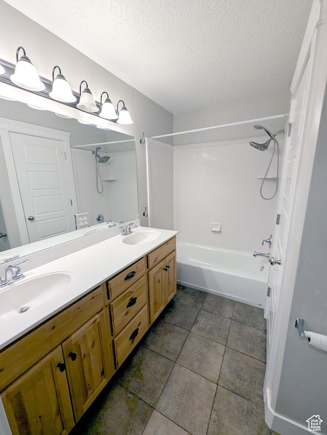 266 W 1010 S, Logan, UT 84321 - bathroom featuring a textured ceiling, double vanity,  shower combination, and tile patterned floors