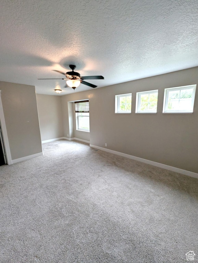 266 W 1010 S, Logan, UT 84321 - spare room with a textured ceiling, a ceiling fan, baseboards, and carpet flooring