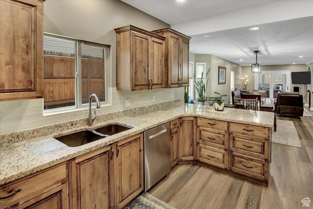 875 E Burch Creek Holw S, South Ogden, UT 84403 - kitchen featuring stainless steel dishwasher, wood finished floors, a sink, brown cabinetry, and recessed lighting