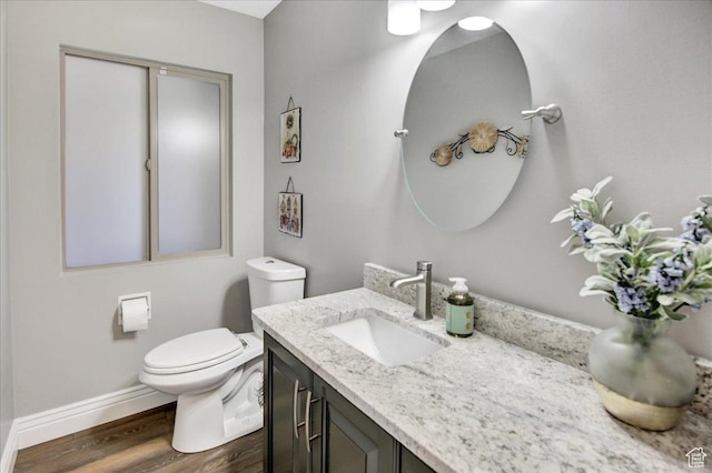 875 E Burch Creek Holw S, South Ogden, UT 84403 - bathroom featuring toilet, wood finished floors, vanity, and baseboards