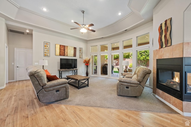living room with a fireplace, recessed lighting, light wood-style flooring, and ceiling fan