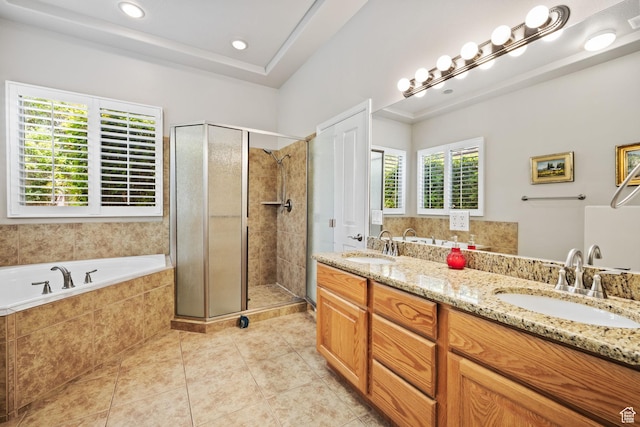 bathroom featuring tile patterned floors, a stall shower, double vanity, a bath, and recessed lighting