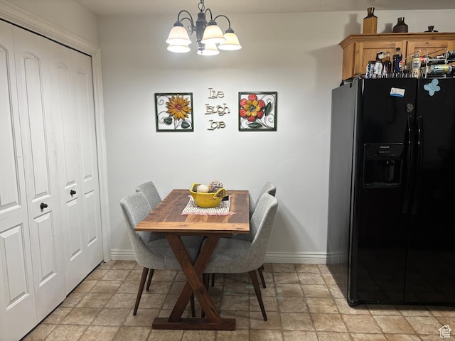 952 W 270 S Unit 202, Pleasant Grove, UT 84062 - dining space with stone finish flooring, a chandelier, and baseboards