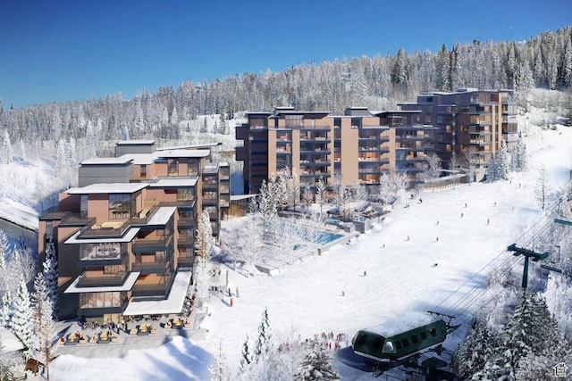 snowy aerial view with a forest view