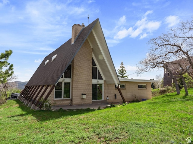 360 Crestview Dr, Park City, UT 84098 - rear view of house featuring a patio area, brick siding, a chimney, and a lawn