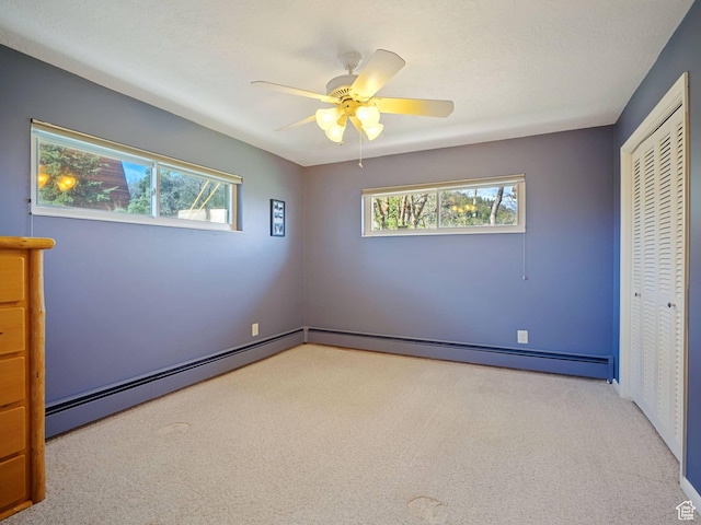 360 Crestview Dr, Park City, UT 84098 - unfurnished bedroom featuring light colored carpet, a closet, a baseboard heating unit, and ceiling fan