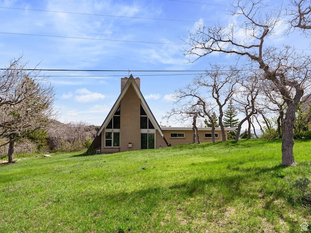 360 Crestview Dr, Park City, UT 84098 - rear view of property featuring a chimney, brick siding, and a lawn