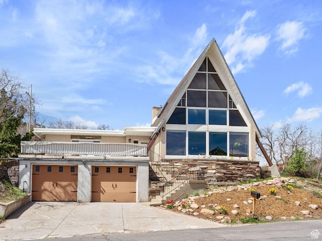 360 Crestview Dr, Park City, UT 84098 - a-frame home featuring concrete driveway, stairway, stucco siding, and a garage
