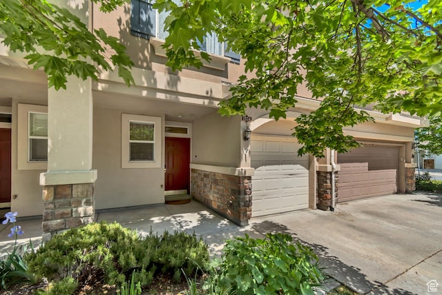 1524 W Napa Ave S, Bluffdale, UT 84065 - view of front of home with stone siding, driveway, stucco siding, and an attached garage