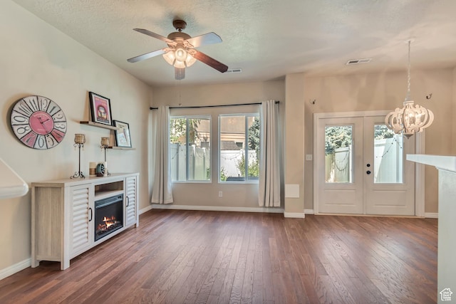 1524 W Napa Ave S, Bluffdale, UT 84065 - entrance foyer with a warm lit fireplace, dark wood-type flooring, ceiling fan, a chandelier, and a textured ceiling