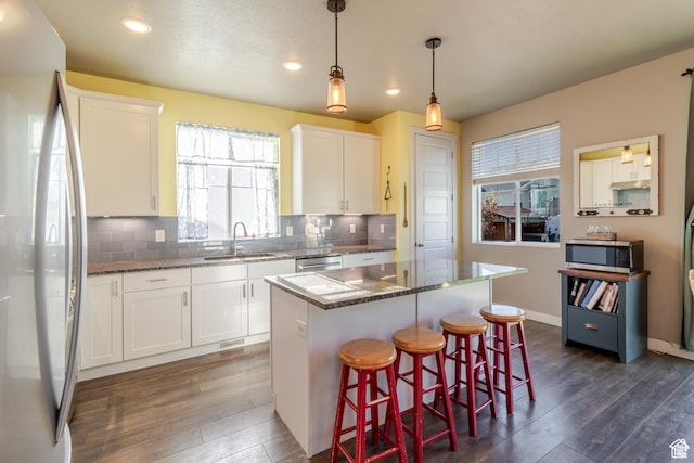 1517 E Kelsey Dr, Eagle Mountain, UT 84005 - kitchen with stainless steel appliances, a sink, plenty of natural light, dark wood-style floors, and recessed lighting