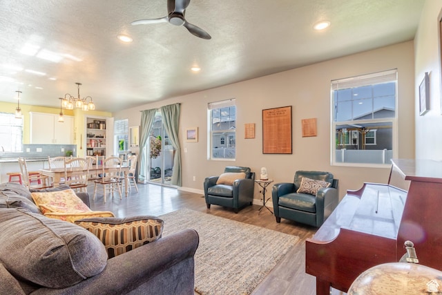 1517 E Kelsey Dr, Eagle Mountain, UT 84005 - living area with ceiling fan, wood finished floors, a chandelier, recessed lighting, and baseboards