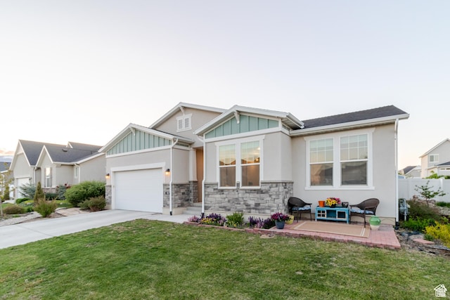 1517 E Kelsey Dr, Eagle Mountain, UT 84005 - view of front facade featuring board and batten siding, concrete driveway, a garage, stone siding, and stucco siding