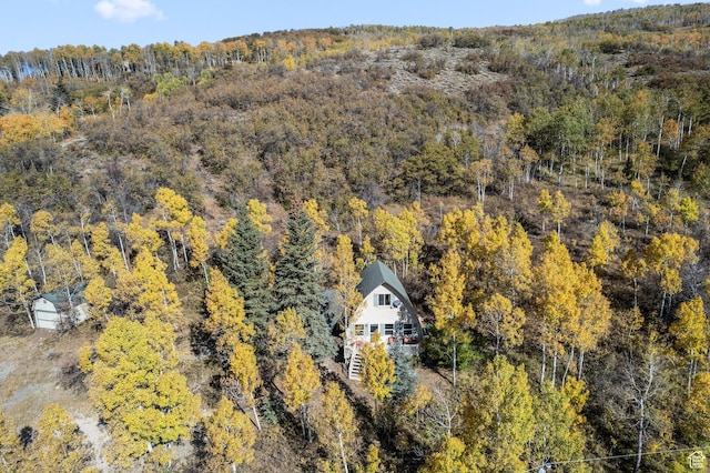 view of subject property with a forest