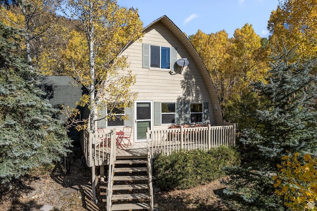 rear view of house featuring a deck