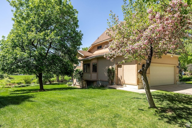 1729 N 1700 E, North Logan, UT 84341 - obstructed view of property with stucco siding, driveway, a garage, and a front yard