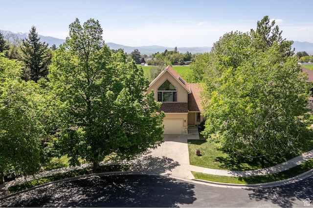 1729 N 1700 E, North Logan, UT 84341 - view of front of home featuring concrete driveway, an attached garage, a mountain view, and stucco siding