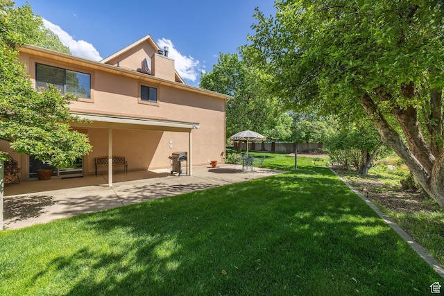 1729 N 1700 E, North Logan, UT 84341 - rear view of house featuring a patio area, stucco siding, and a chimney