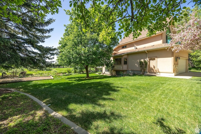 1729 N 1700 E, North Logan, UT 84341 - view of green lawn featuring an attached garage and driveway