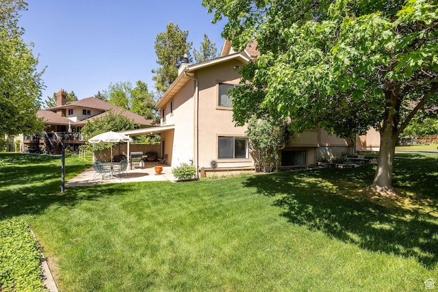 1729 N 1700 E, North Logan, UT 84341 - rear view of property with stucco siding, a yard, and a patio