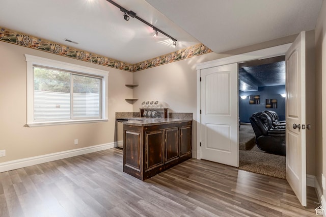 bar with track lighting, wood finished floors, and baseboards