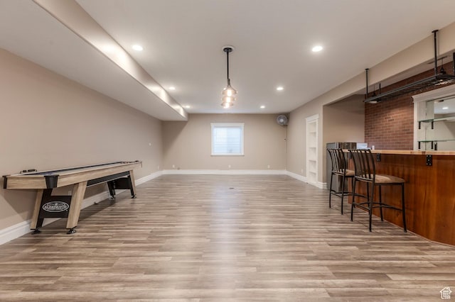 playroom with light wood finished floors, baseboards, a community bar, and recessed lighting