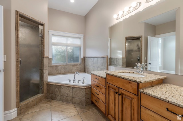 bathroom with a stall shower, a garden tub, and vanity