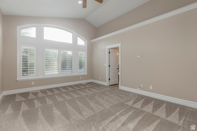 carpeted empty room with a ceiling fan, baseboards, and lofted ceiling