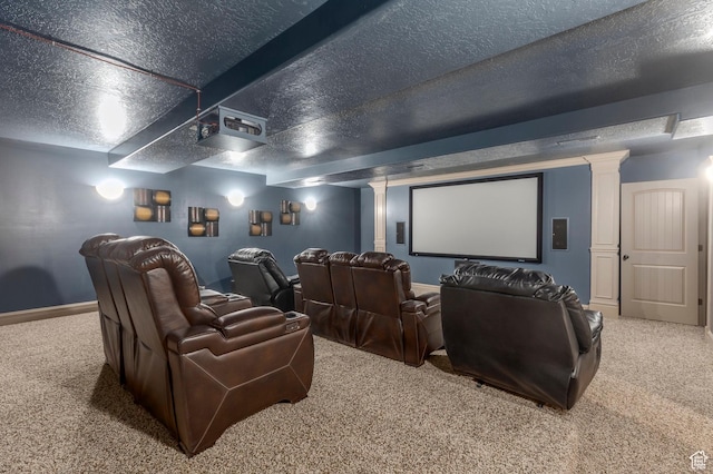 cinema with carpet, decorative columns, baseboards, and a textured ceiling