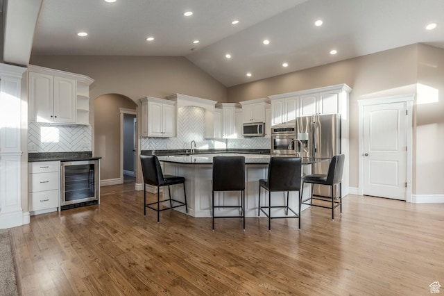 2378 S 550 W, Syracuse, UT 84075 - kitchen with wine cooler, stainless steel appliances, open shelves, lofted ceiling, and white cabinetry