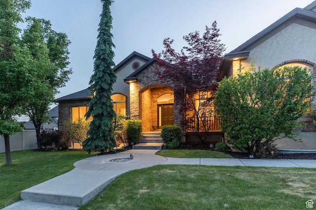 view of front of property featuring stone siding and brick siding