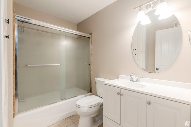full bathroom featuring toilet, tile patterned flooring, vanity, and shower / bath combination with glass door