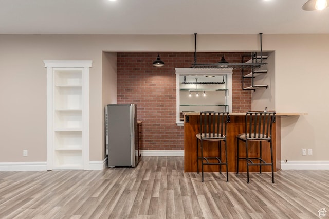 2378 S 550 W, Syracuse, UT 84075 - indoor dry bar featuring baseboards, wood finished floors, built in shelves, and brick wall