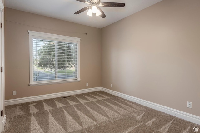 carpeted empty room with baseboards and ceiling fan