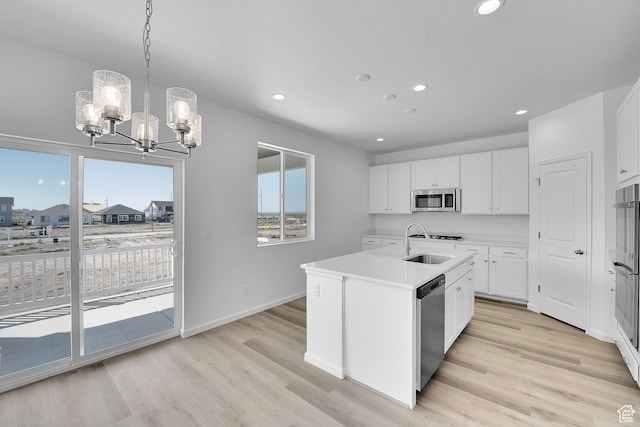 241 W 825 S Unit 305, Willard, UT 84340 - kitchen with appliances with stainless steel finishes, a chandelier, a sink, plenty of natural light, and recessed lighting