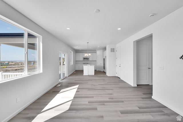241 W 825 S Unit 305, Willard, UT 84340 - unfurnished living room with recessed lighting, baseboards, light wood-style floors, and a chandelier