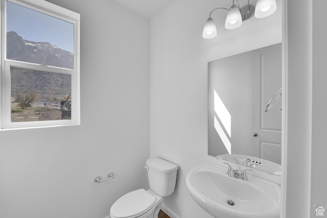 241 W 825 S Unit 305, Willard, UT 84340 - half bath featuring a sink, toilet, a chandelier, and a mountain view