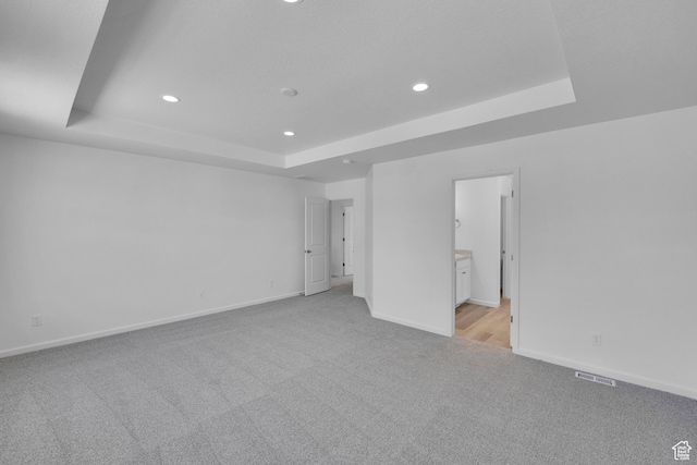241 W 825 S Unit 305, Willard, UT 84340 - unfurnished bedroom with a raised ceiling, light carpet, recessed lighting, baseboards, and ensuite bathroom